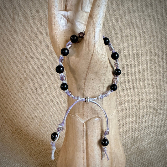 Lavender Hemp & Linen Bracelet with Shungite & Shimmery Lavender Beads draped on wooden hand