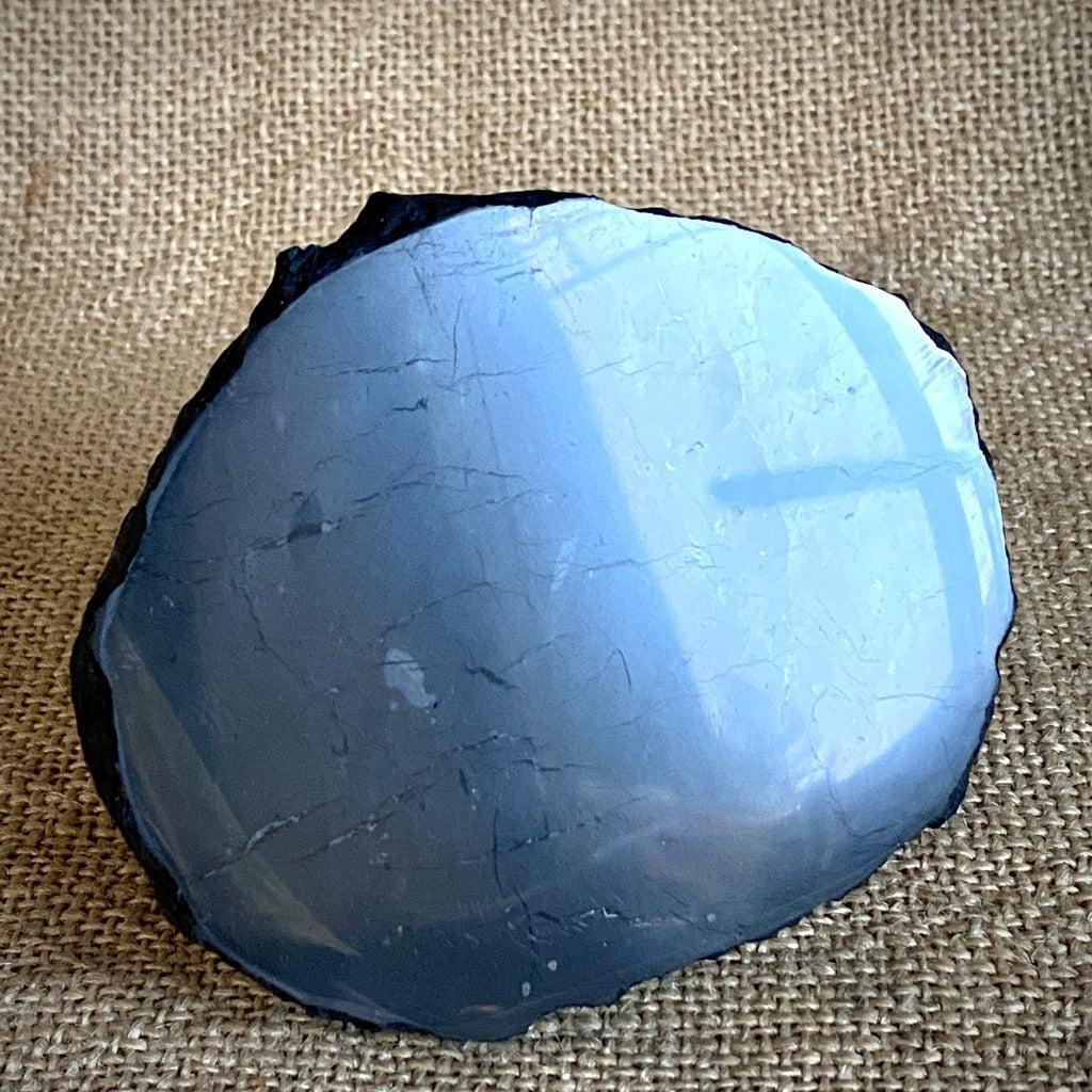Peruvian Leopardite Skull on Polished Shungite Slab with Raw Edge