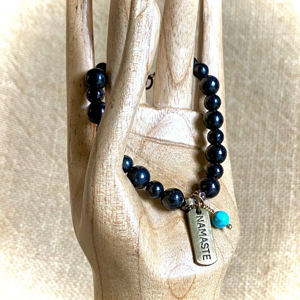 Shungite Namaste Bracelet with Turquoise Bead Dangle hanging view