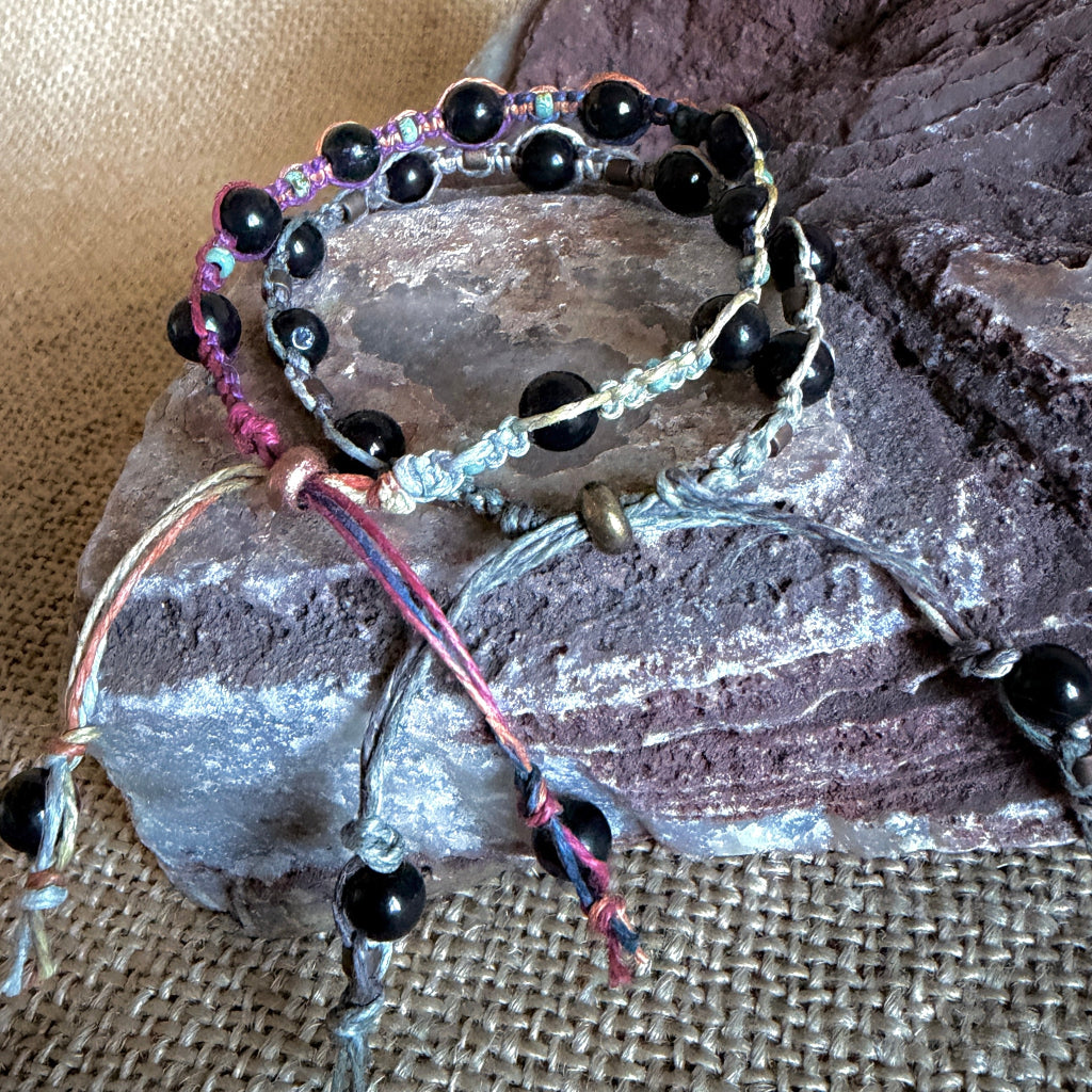 Shungite Macrame Bracelet with Variegated Hemp shown on stone