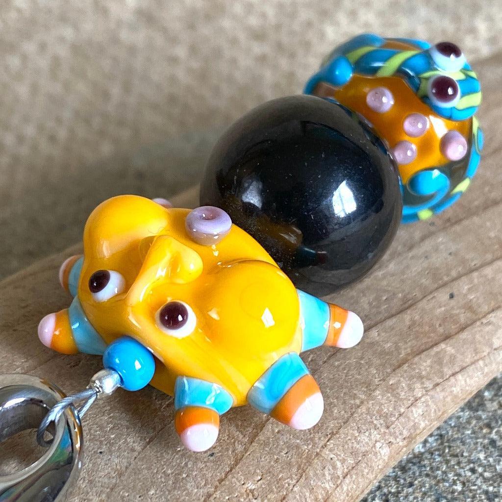 Shungite Clip-on, Necklace, Whimsical Orange Sun Face, Lampwork Glass