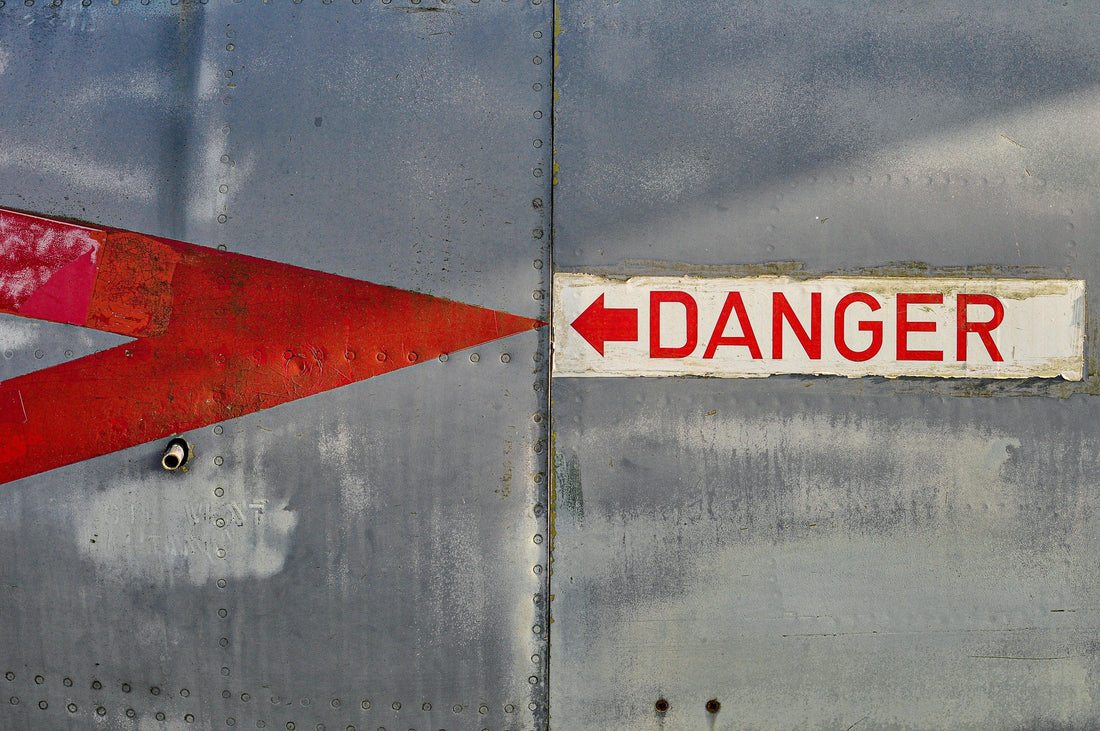 Danger sign on metal surface warning about EMF radiation risks to bone health