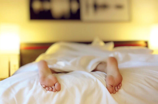 Person's feet who is lying in bed having a detox reaction
