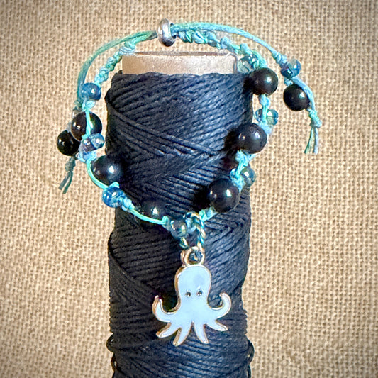 Adjustable Shungite Bracelet for Kids | Bluegreen Hemp, White Octopus on spool of black hemp