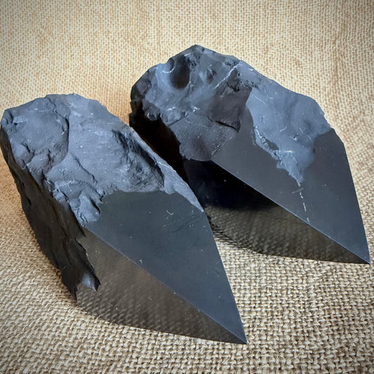 Large Raw Shungite Points lying on burlap table point end view