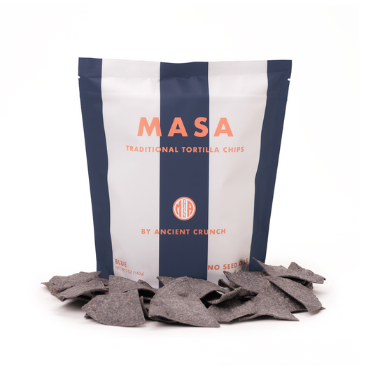 Bag of MASA traditional tortilla chips with chips spilling out on a white background