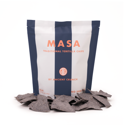Bag of MASA traditional tortilla chips with chips spilling out on a white background