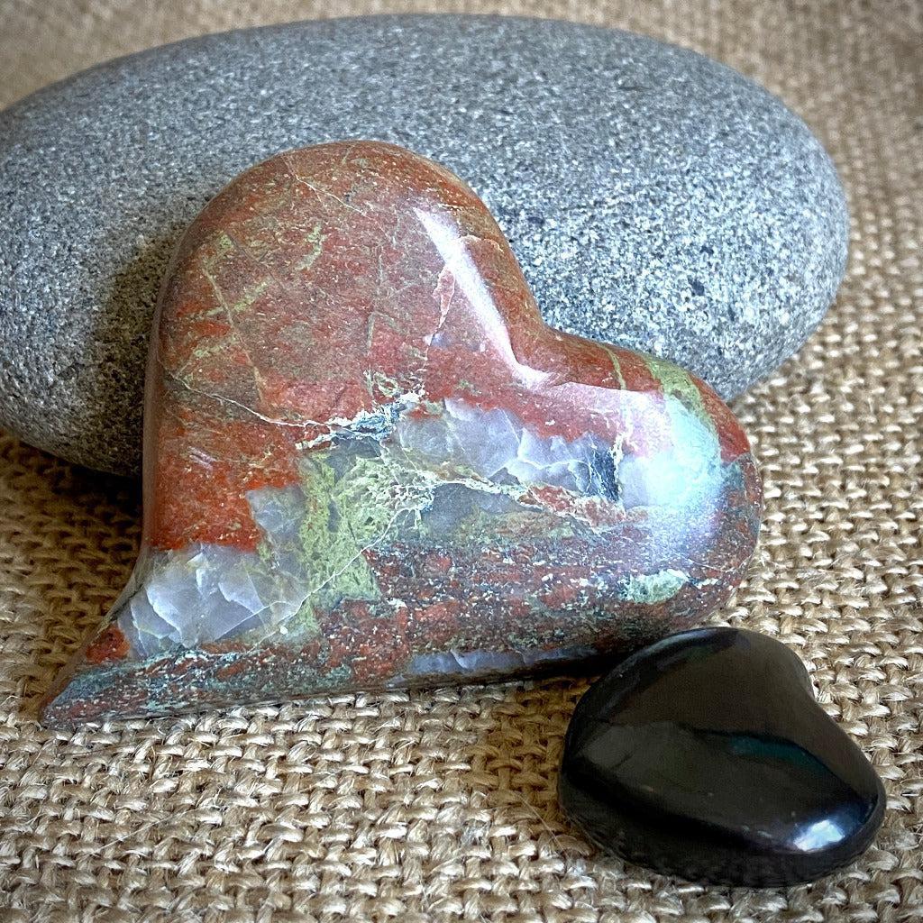 Playful Carved Stone Heart & Black Shungite Heart on Mahogany Stand