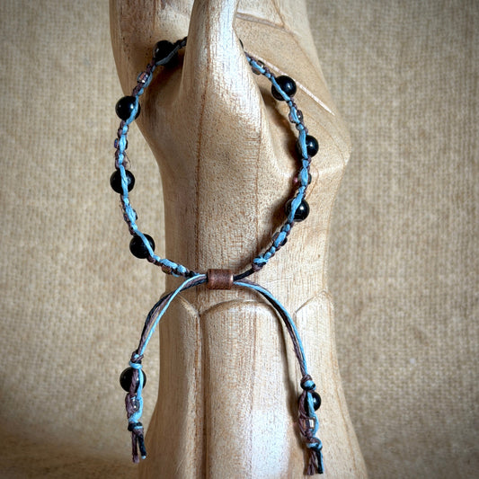 Shungite Macrame Bracelet on Blue & Brown Hemp draped on wooden hand