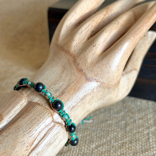 Shungite Macrame Bracelet on Green & Tan Hemp on wooden wrist