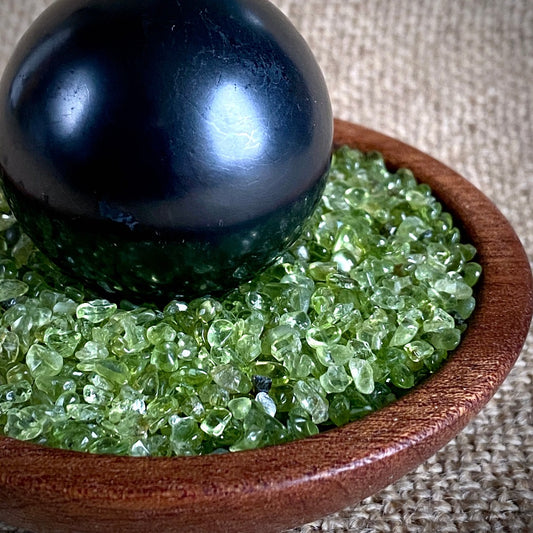 Shungite Sphere on Tumbled Green Peridot in Custom Mahogany Bowl