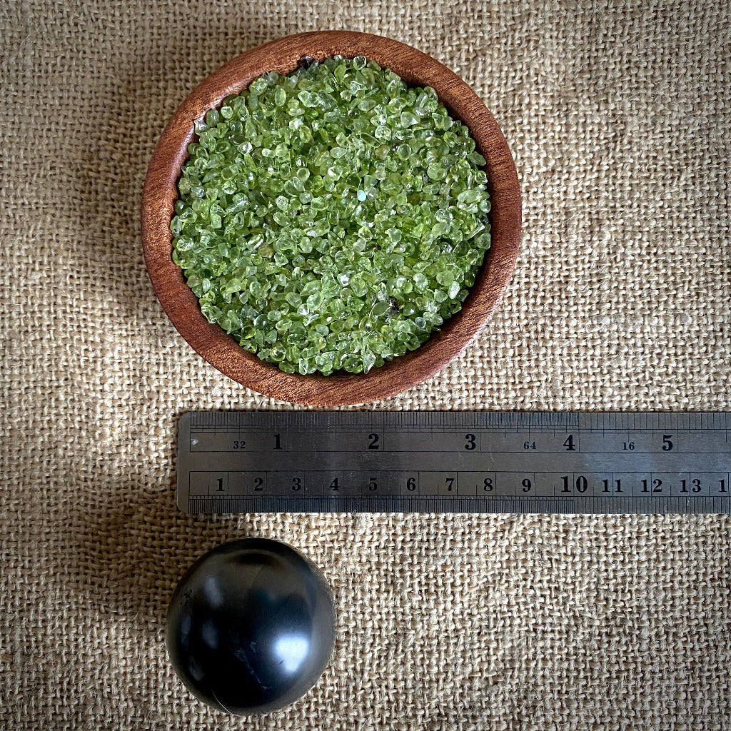 Shungite Sphere on Tumbled Green Peridot in Custom Mahogany Bowl