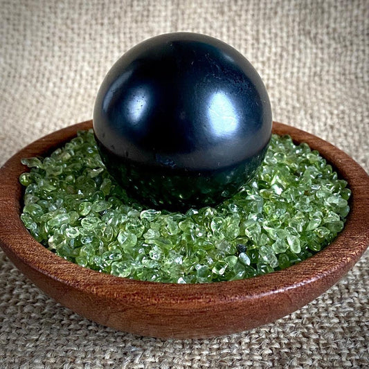 Shungite Sphere on Tumbled Green Peridot in Custom Mahogany Bowl